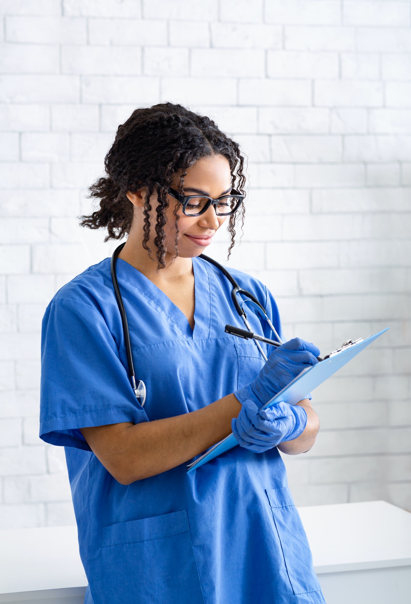 Portrait of young black female veterinarian at work in animal clinic